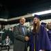 A graduate shacks the hand of a faculty member as she waits to receive her diploma during Pioneer's class of 2013 graduation ceremony at the Convocation Center, Thursday, June 6. Courtney Sacco I AnnArbor.com